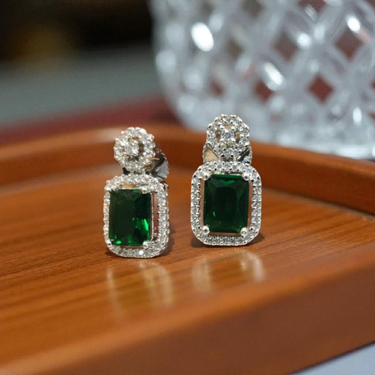 Pair of emerald green gemstone earrings with silver accents.