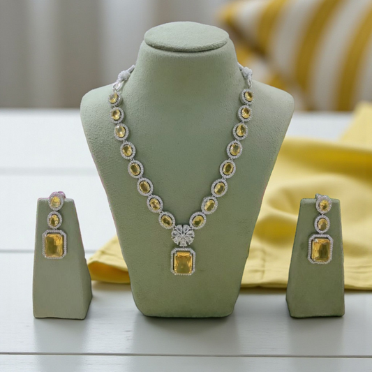 Elegant yellow gemstone necklace and earring set with oval stones and floral pendant